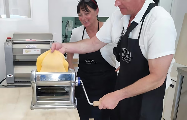 Happy student cooking pasta